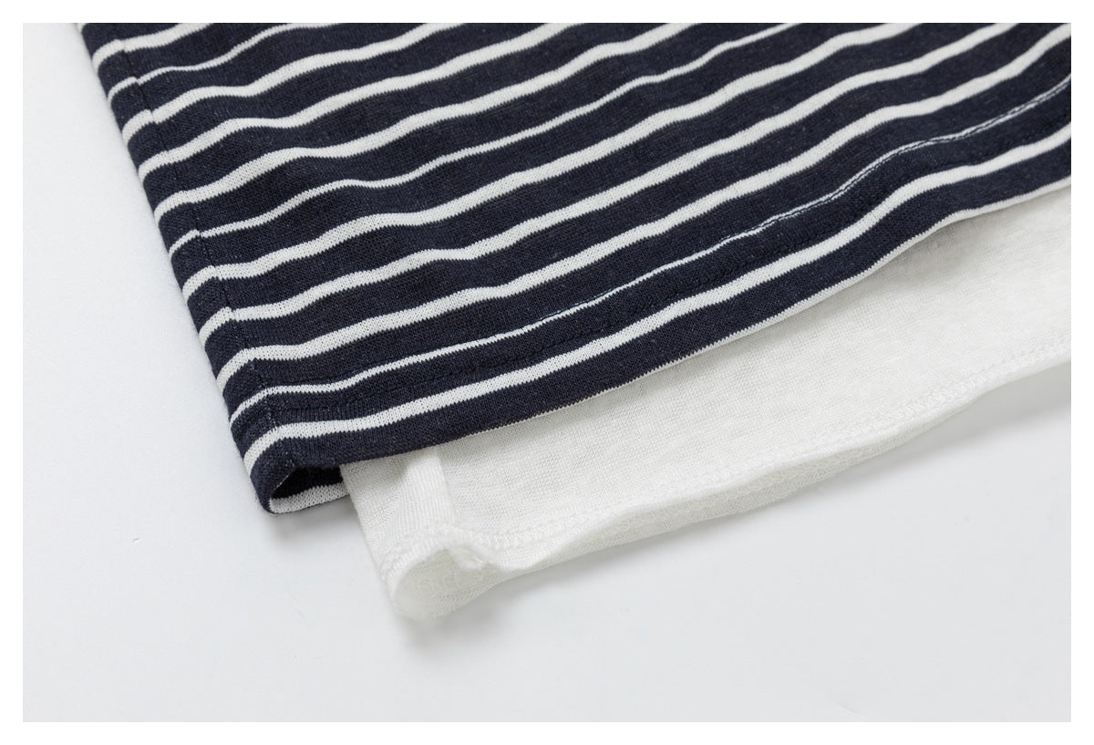 Close-up of the navy-and-white striped top's hem layered over a plain white underlayer.