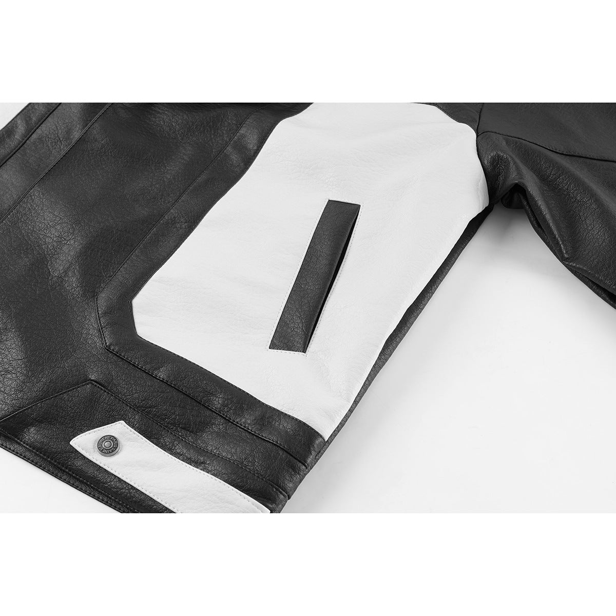 Close-up of a black jacket with a large white panel and a narrow black inset.