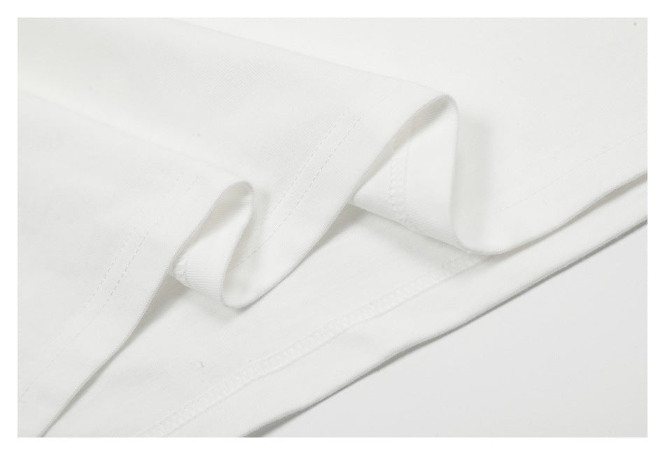 Close-up of a white garment's folded hem with visible stitching and layered fabric.