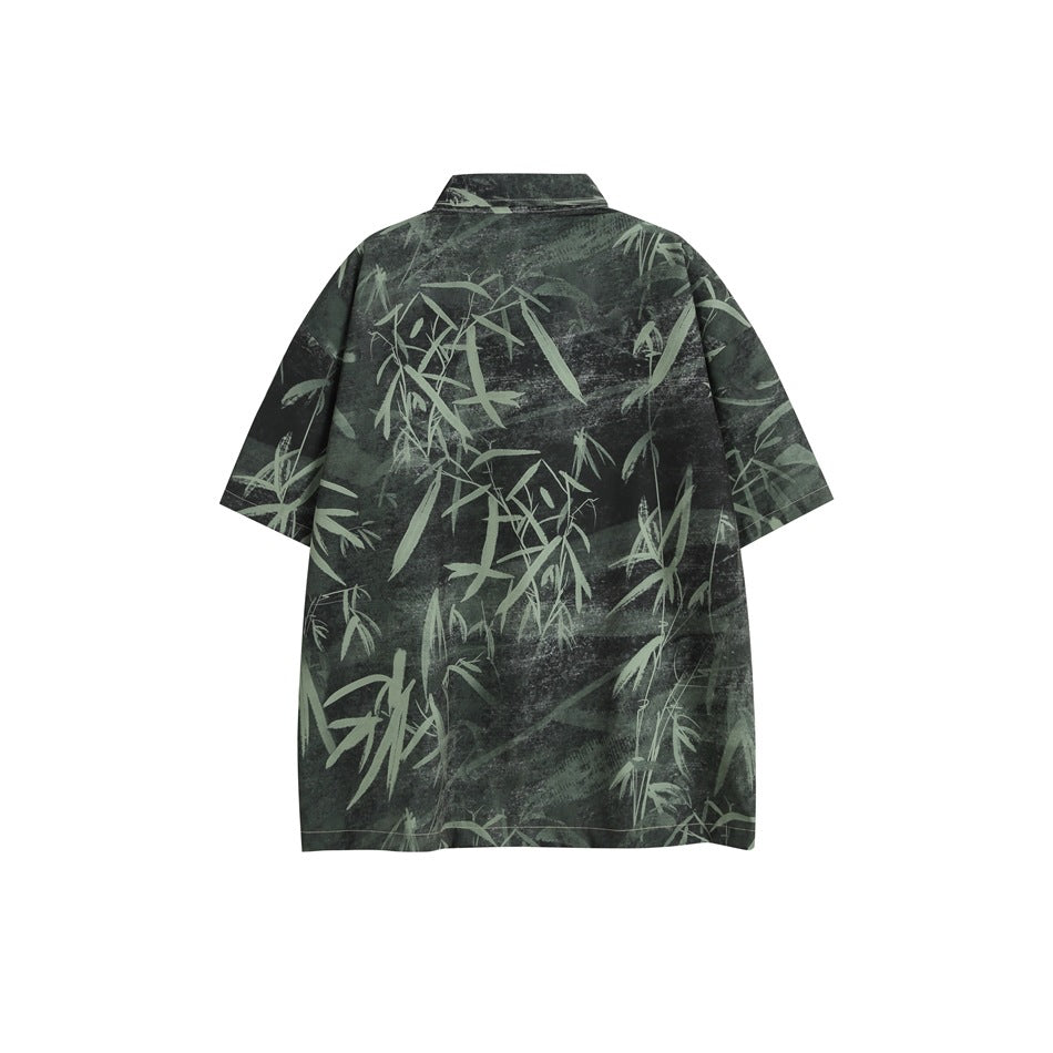 Back view of a charcoal short-sleeve shirt with a pale green bamboo print and a pointed collar.