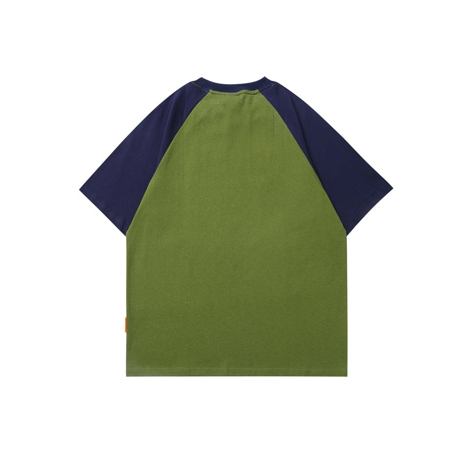 Back view of green T-shirt with navy raglan sleeves and collar, plain back with small orange tag at hem