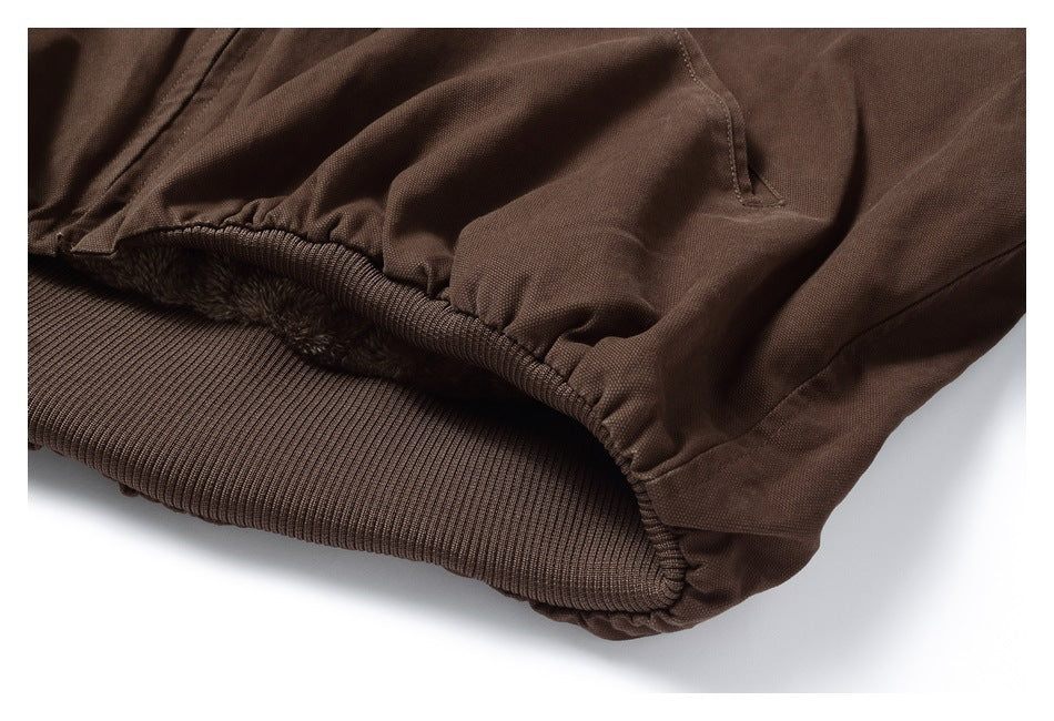 Close-up of a dark brown jacket hem with ribbed trim and visible plush lining.