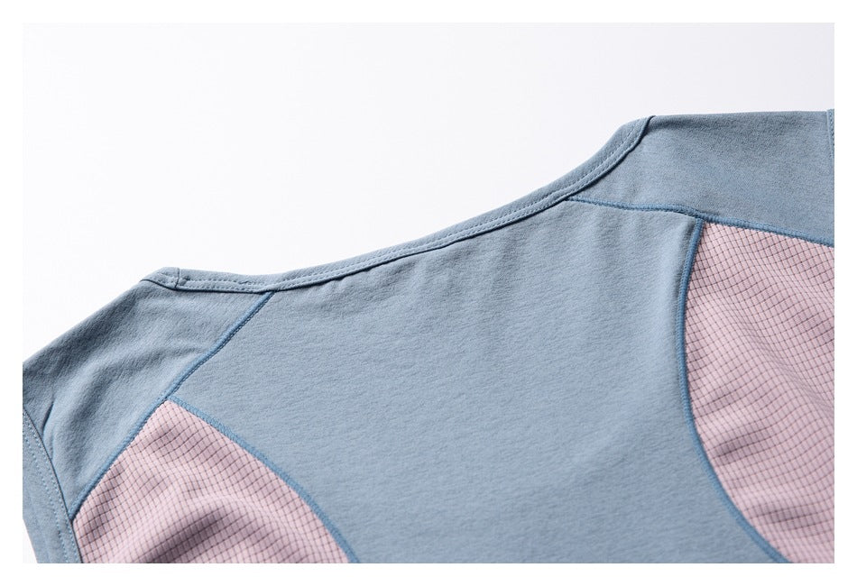 Close-up of the blue garment's back neckline and curved pink grid-patterned shoulder inserts.