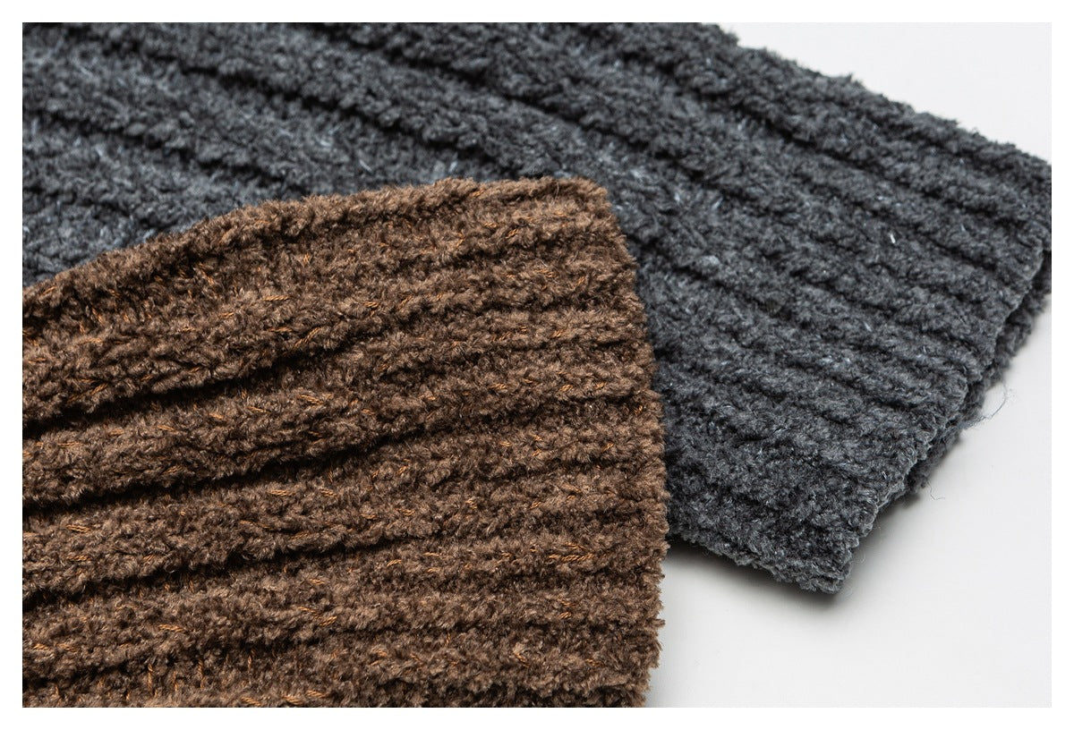 Close-up of chunky rib-knit fabric in brown and charcoal gray, arranged overlapping.
