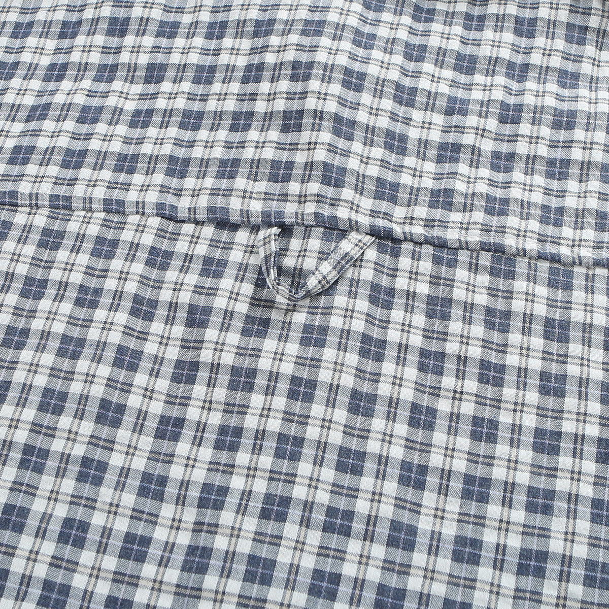 Close-up of the back yoke seam and hanging loop on a blue-gray and white plaid shirt.