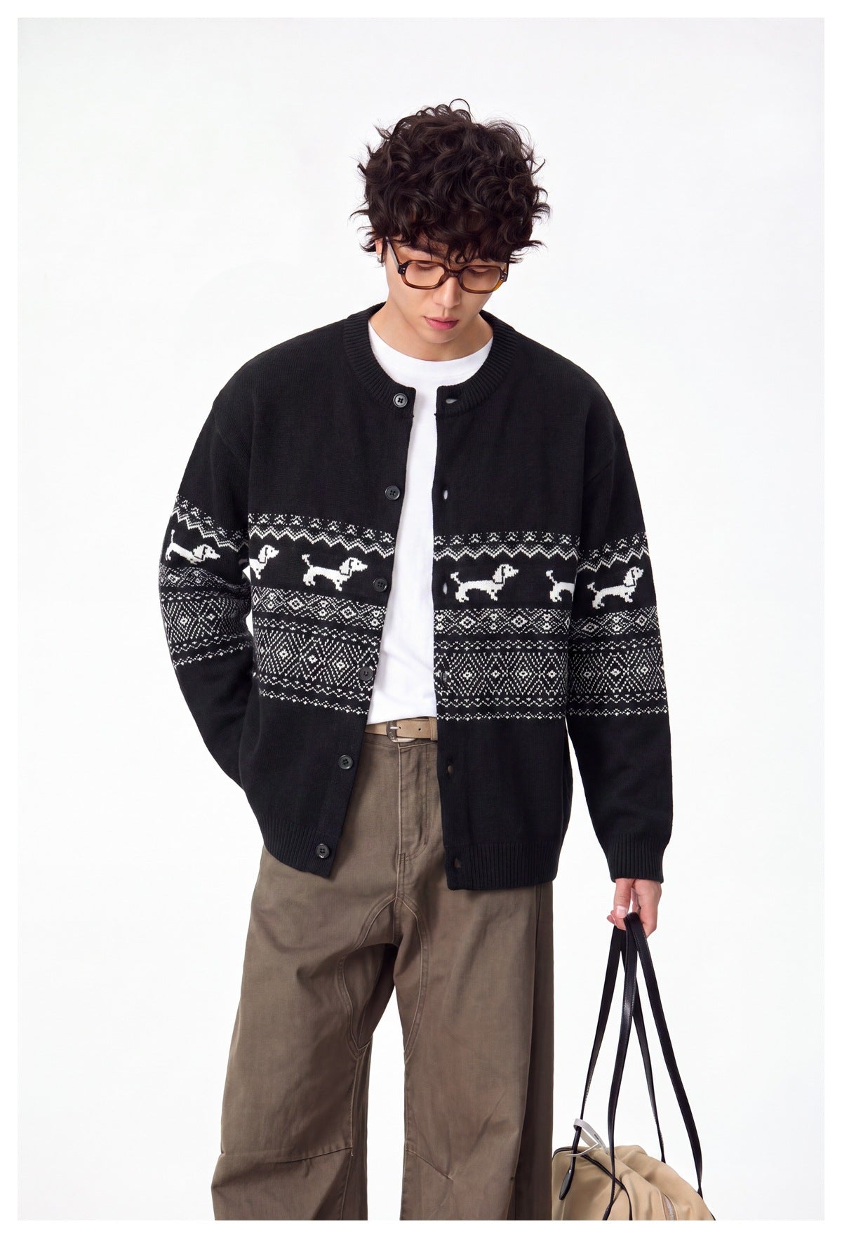 Model wearing an open black cardigan with white dog motifs and geometric bands, over a white shirt.