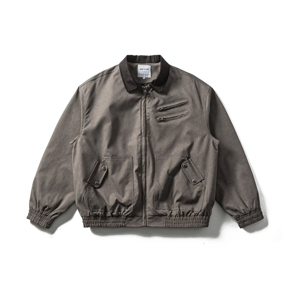 Dark gray zip-front jacket with brown collar, zippered chest pockets, flap pockets and elastic hem, flat lay front view