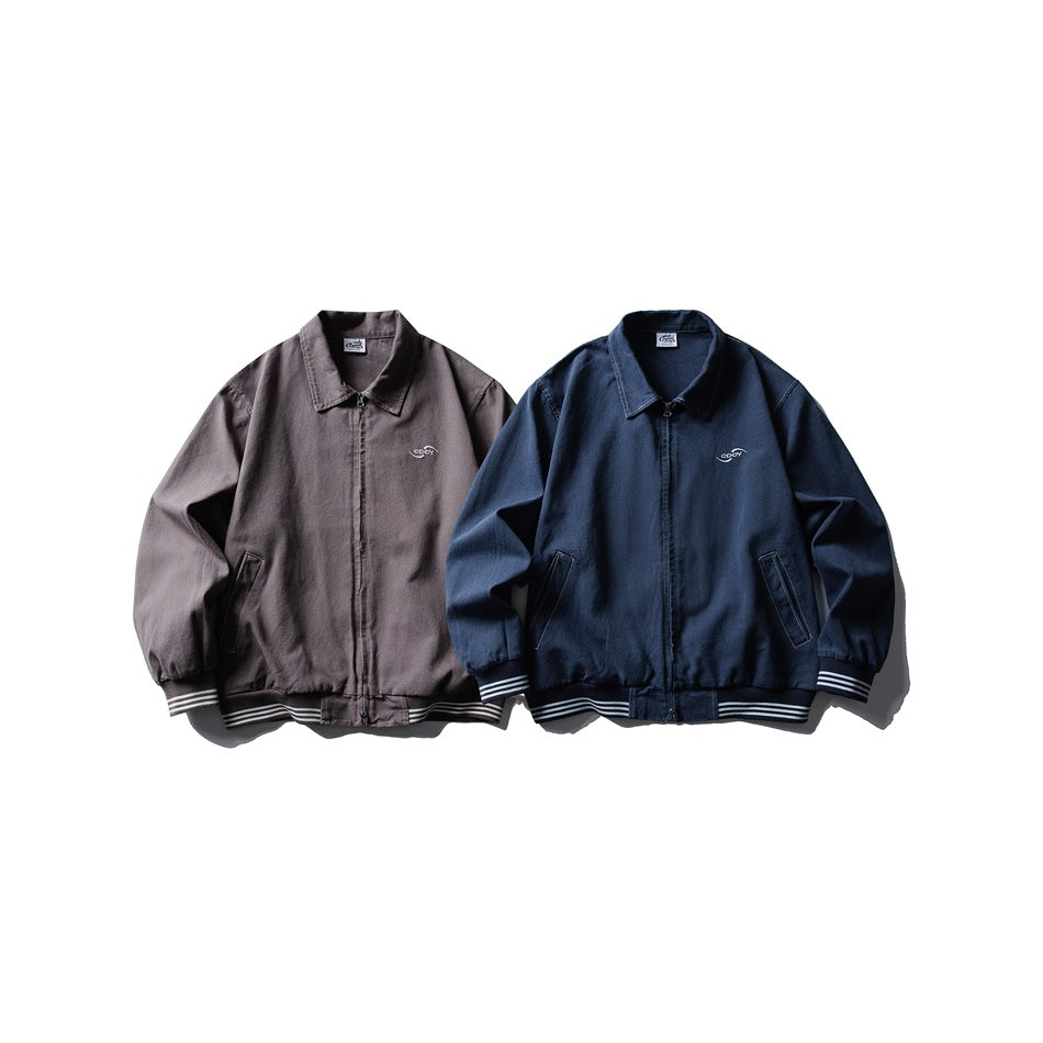 Two zip-front jackets shown from the front in charcoal gray and navy, with striped ribbed trim.