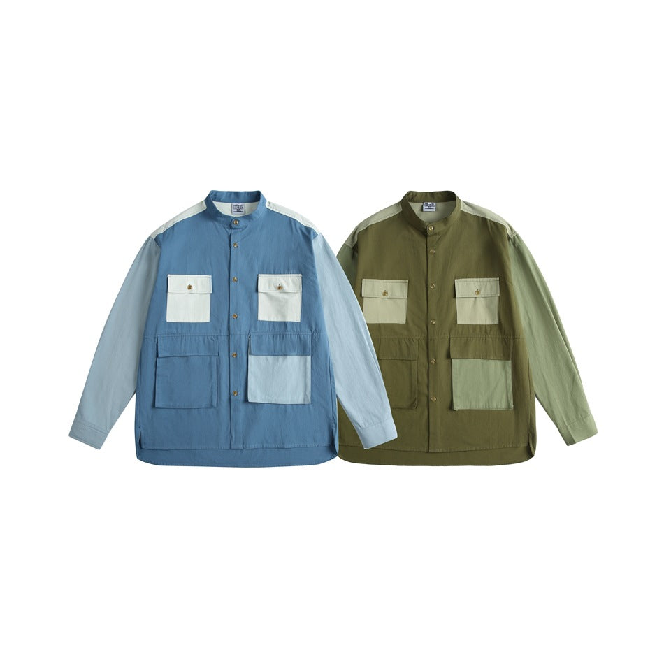 Two front-view band-collar shirts with flap pockets, shown in blue and olive colorways with pale contrasting panels.