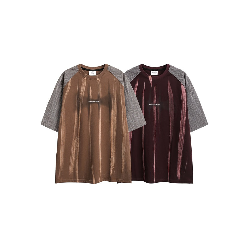 Two short-sleeve raglan shirts shown flat, one brown and one burgundy, both with gray patterned sleeves.