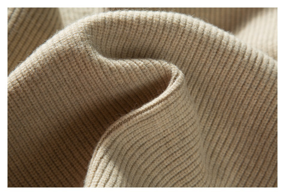 Close-up of a folded rib-knit neckline or collar in beige fabric.