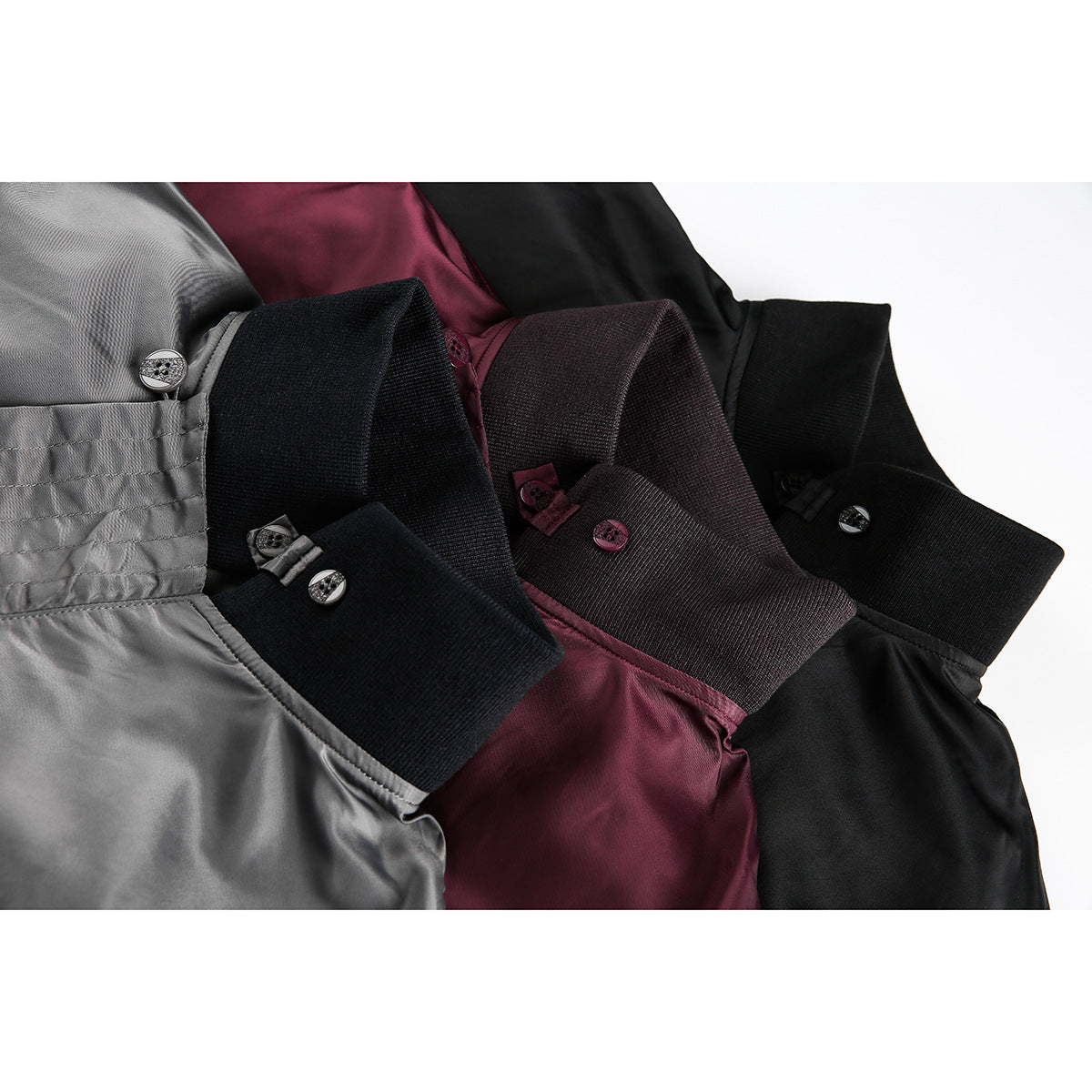 Close-up of jacket collars and buttoned cuffs in gray, burgundy, and black.