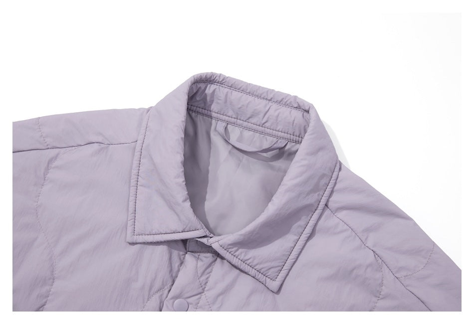 Close-up of the lavender jacket's pointed collar, inner hanging loop and quilted shoulder seams.