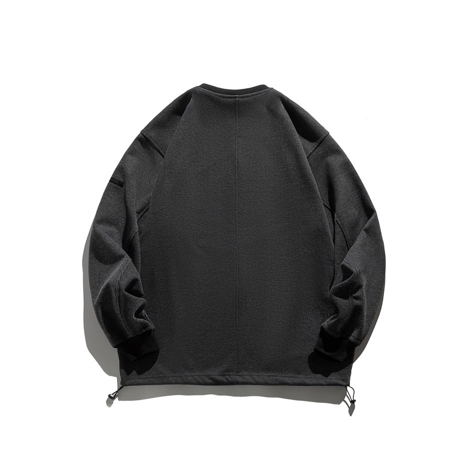 Back view of a charcoal gray sweatshirt with long sleeves, a center seam, and adjustable drawcords at the hem.