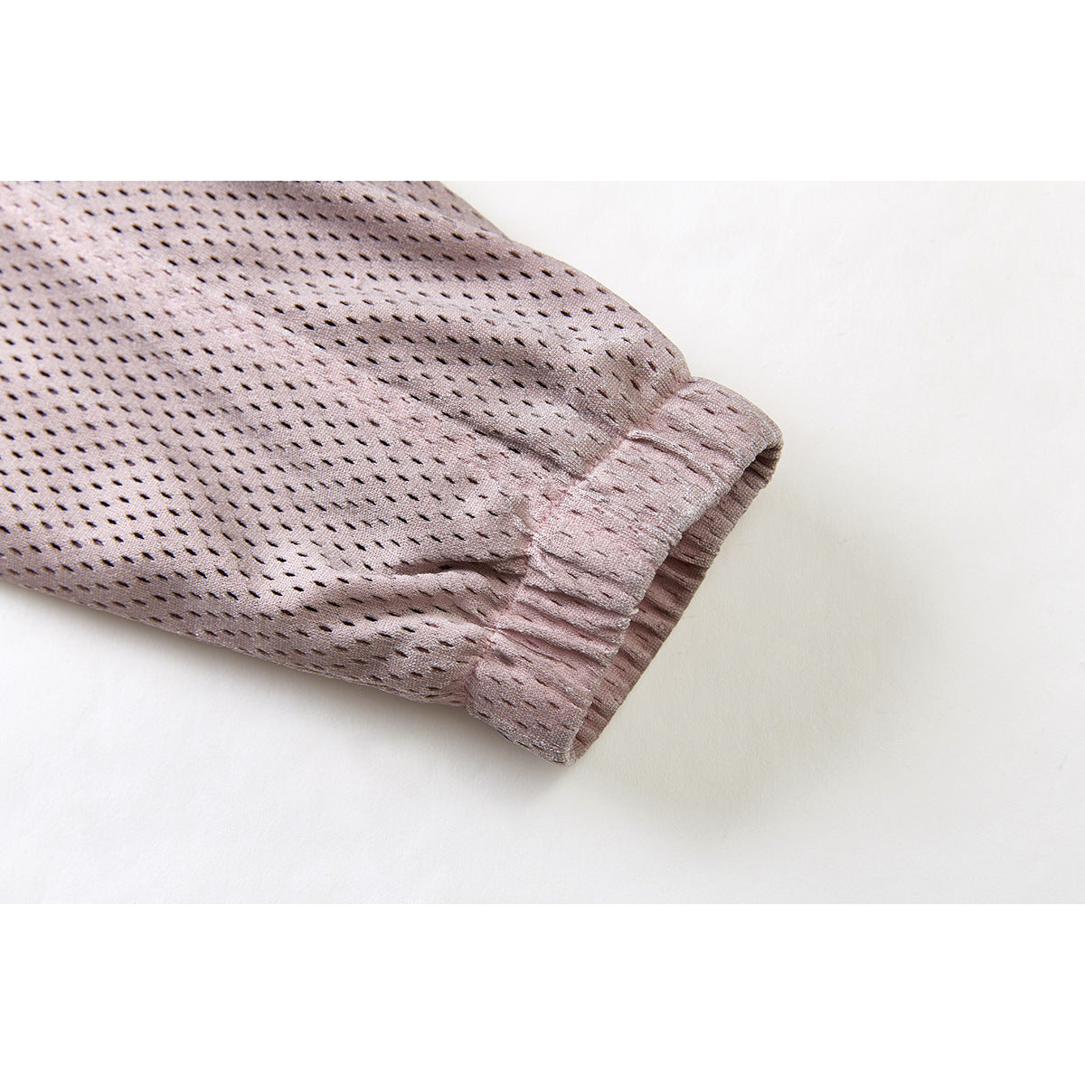 Close-up of the dusty mauve jacket sleeve and gathered elastic cuff.