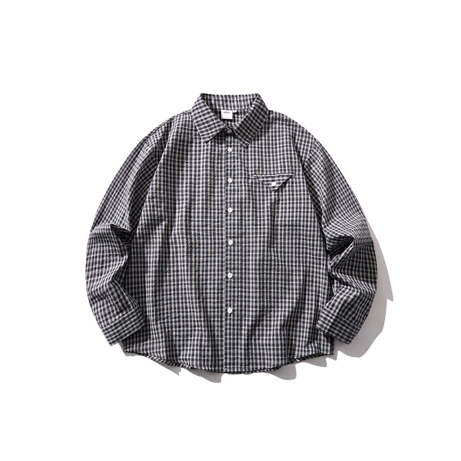 Blue and white small-check long-sleeve button-up shirt with triangular chest pocket, laid flat, front view