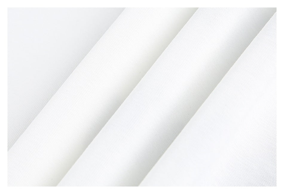 Close-up of white garment fabric arranged in overlapping folds.