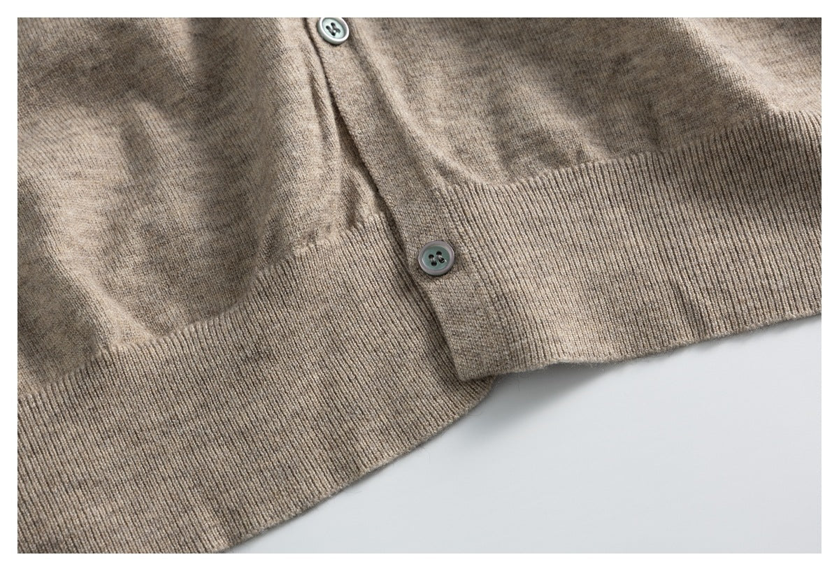 Close-up of a taupe button-front cardigan showing its buttons and ribbed hem.