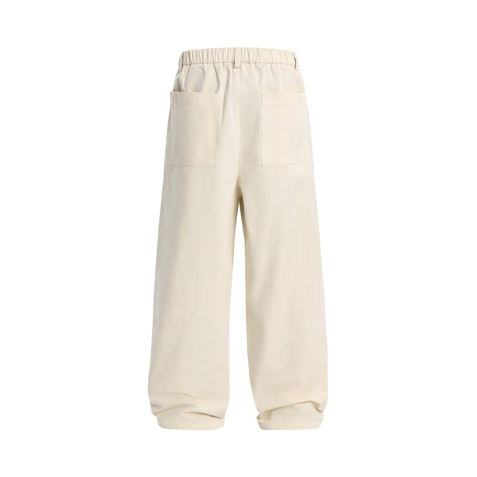 Back view of ivory wide-leg trousers with an elastic waistband and two patch pockets.