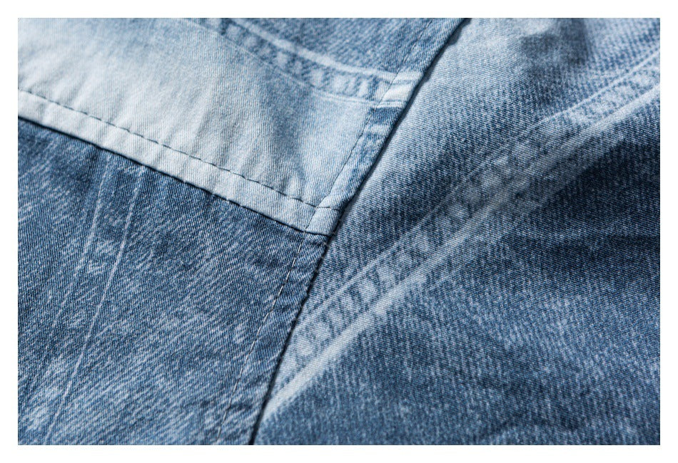 Close-up of intersecting panel seams and contrasting faded areas on blue denim.