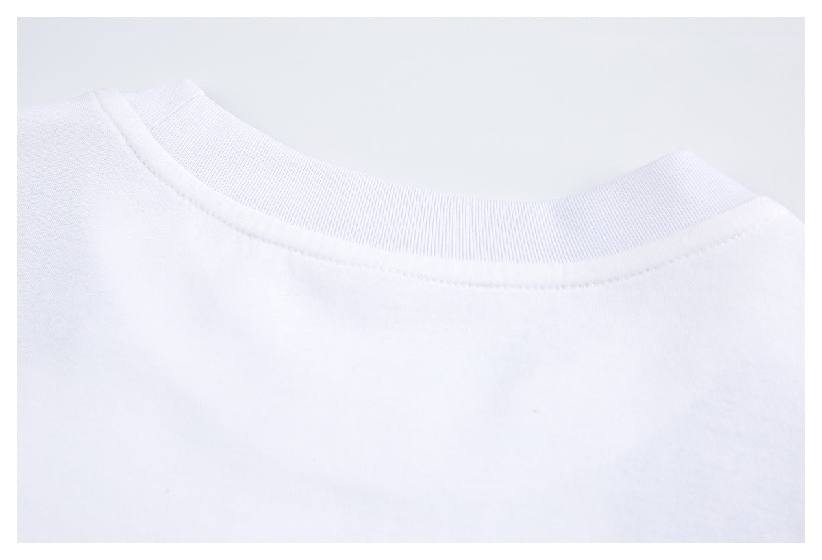 Close-up of a white crew-neck shirt showing its ribbed collar and neckline stitching.