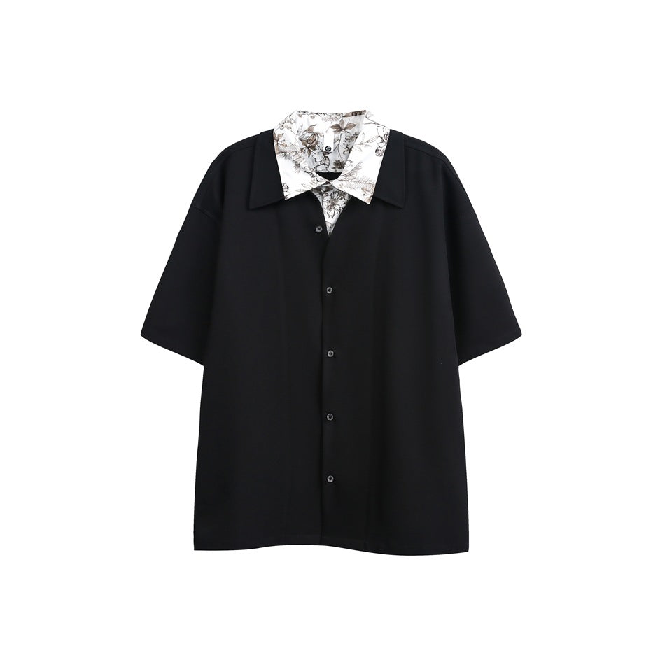 Black short-sleeve button-up shirt with floral-print white collar layered underneath, flat front view