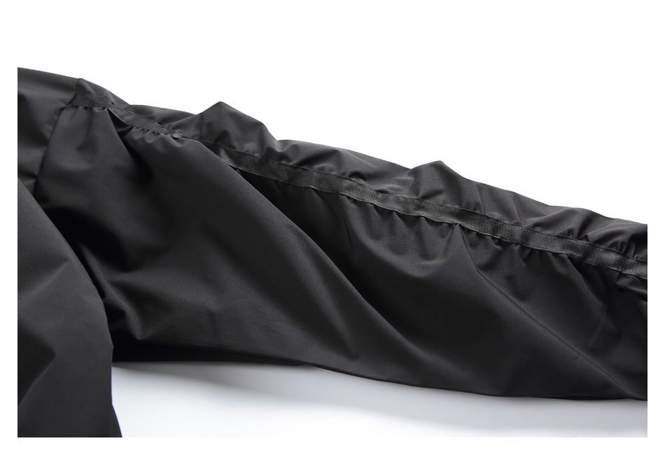 Close-up of a black garment with a long reinforced seam and stitching.