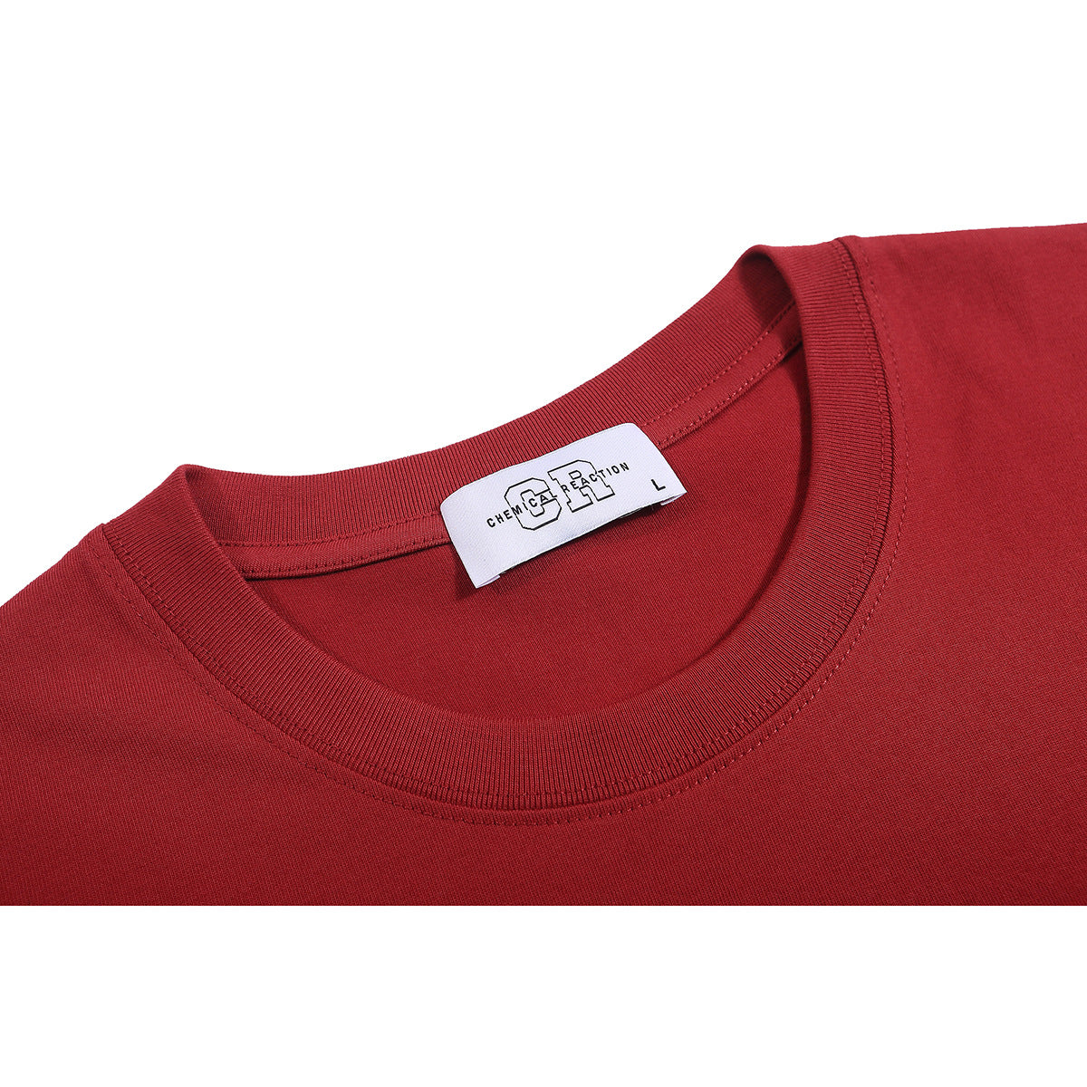 Close-up of a red T-shirt’s ribbed crew neck and white inner label with English lettering.