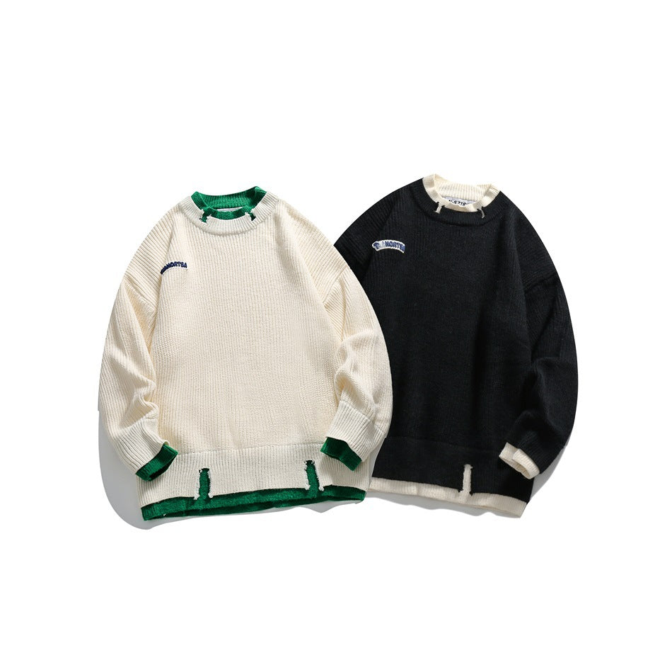 Two sweaters shown together: ivory with green trim and black with cream trim, both with contrast hem details.