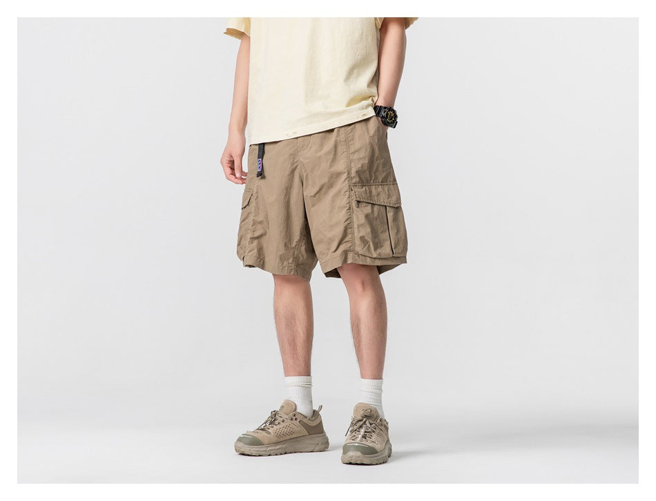 Three-quarter view of a model wearing tan cargo shorts with roomy flap pockets.