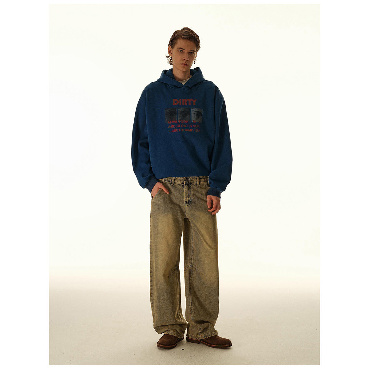 Full-length model wearing a dark blue graphic hoodie with loose, wide-leg washed-brown jeans.