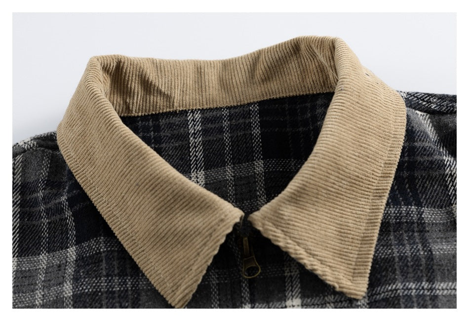 Close-up of a charcoal plaid jacket's wide tan ribbed collar and front zipper.