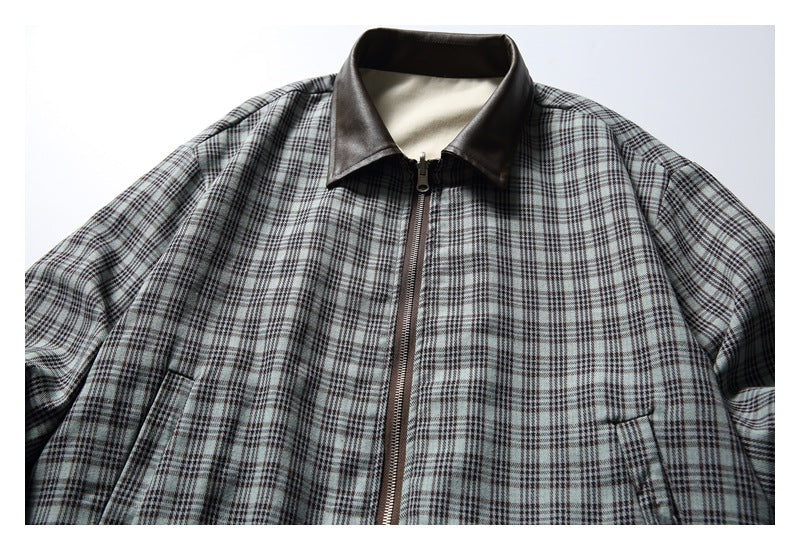 Front of a gray plaid zip-up jacket with a dark brown collar and angled pockets.