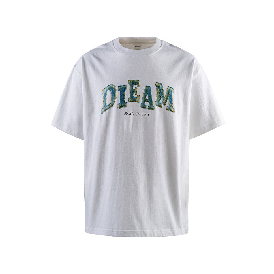 White short-sleeve crew-neck T-shirt with blue-green arched DIEAM graphic and Built to Last script, flat front view