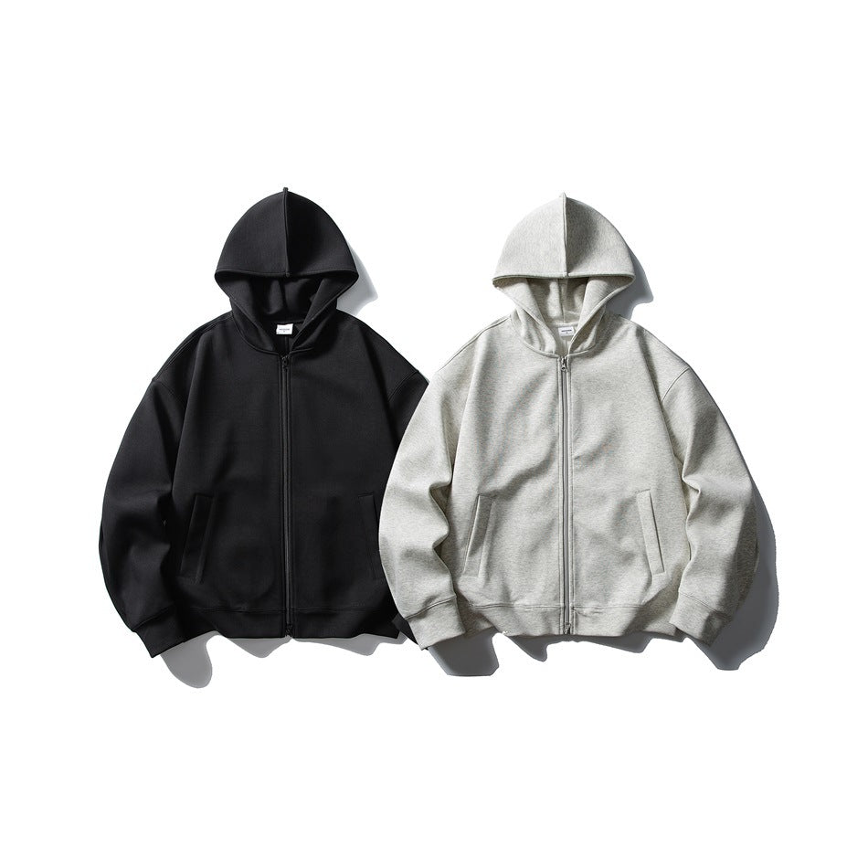 Front view of two hooded zip-up sweatshirts laid flat, one black and one light gray heather.