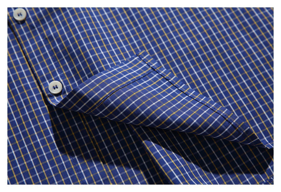 Close-up of the blue plaid shirt's chest pocket and button placket.