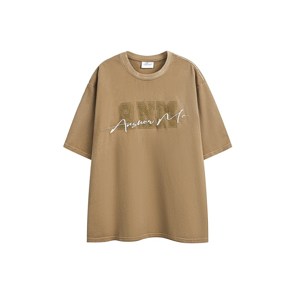 Khaki short-sleeve crew-neck T-shirt with white Answer Me script embroidery over a tonal ANM patch