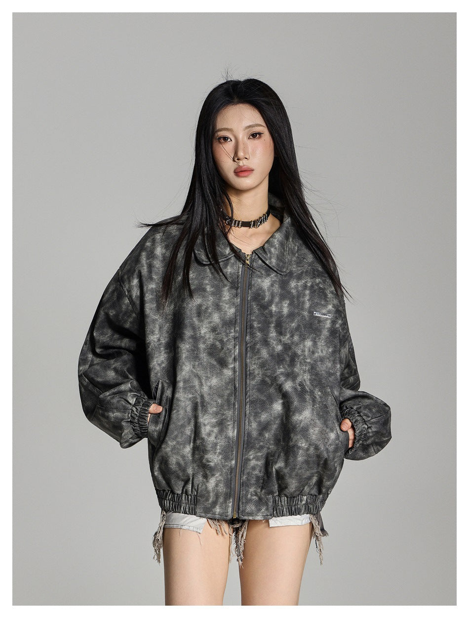 Model wearing an oversized mottled charcoal-gray zip jacket with a wide collar and elastic cuffs and hem.
