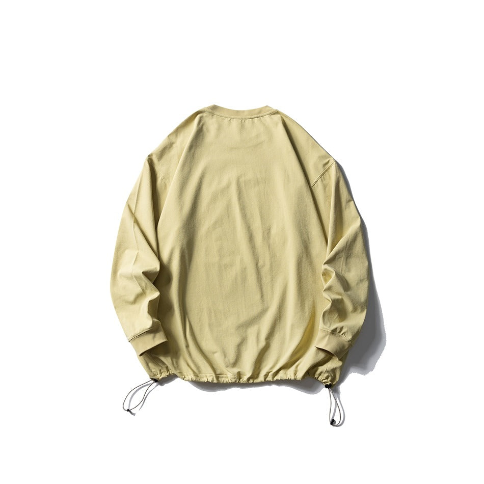 Back view of a pale yellow long-sleeve crewneck pullover with ribbed cuffs and adjustable drawcords at the hem.
