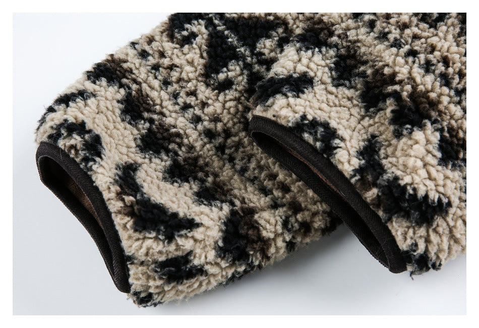 Close-up of two rounded openings edged in black on plush beige, brown, and black patterned fleece.