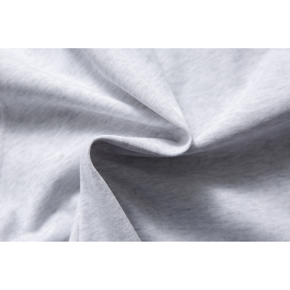 Close-up of light gray fabric draped to show its surface and edge.