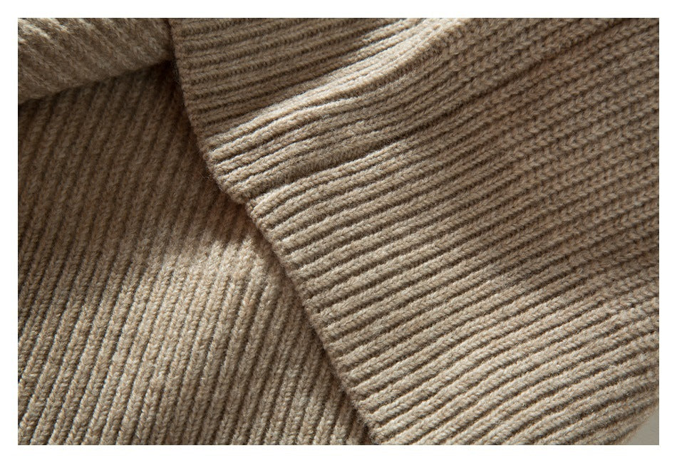 Close-up of a beige rib-knit sleeve and its cuff.