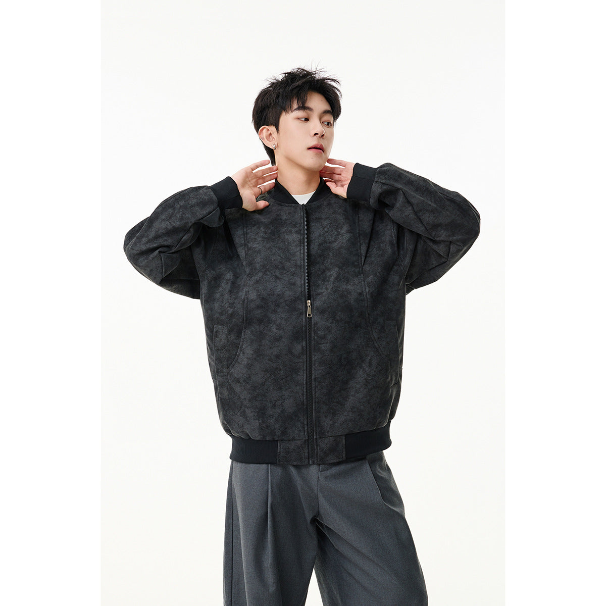 Model wearing a mottled charcoal zip-front bomber jacket with ribbed trim and a stand collar.