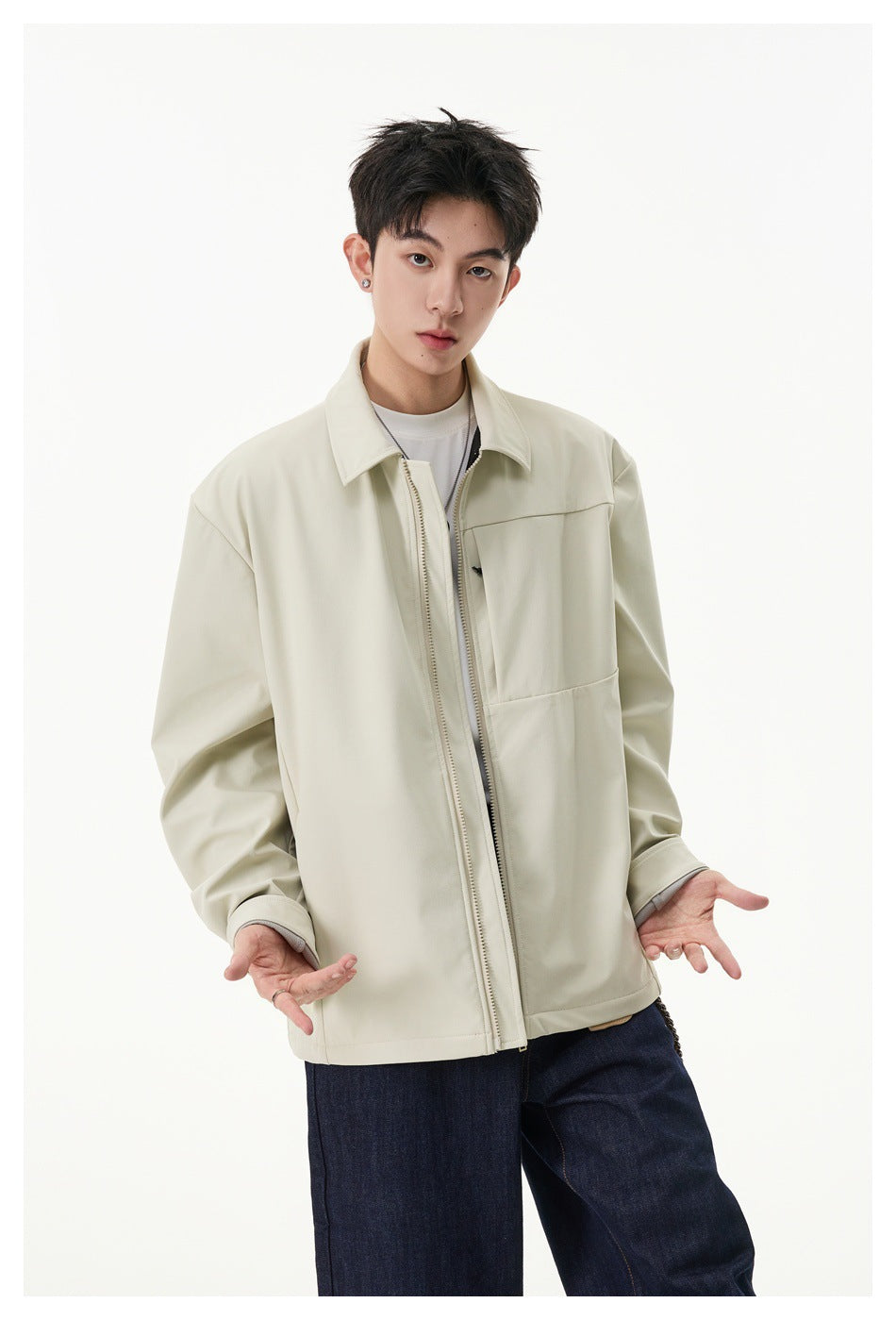 Model wearing an ivory zip-front jacket with a pointed collar, chest panel and adjustable cuffs.