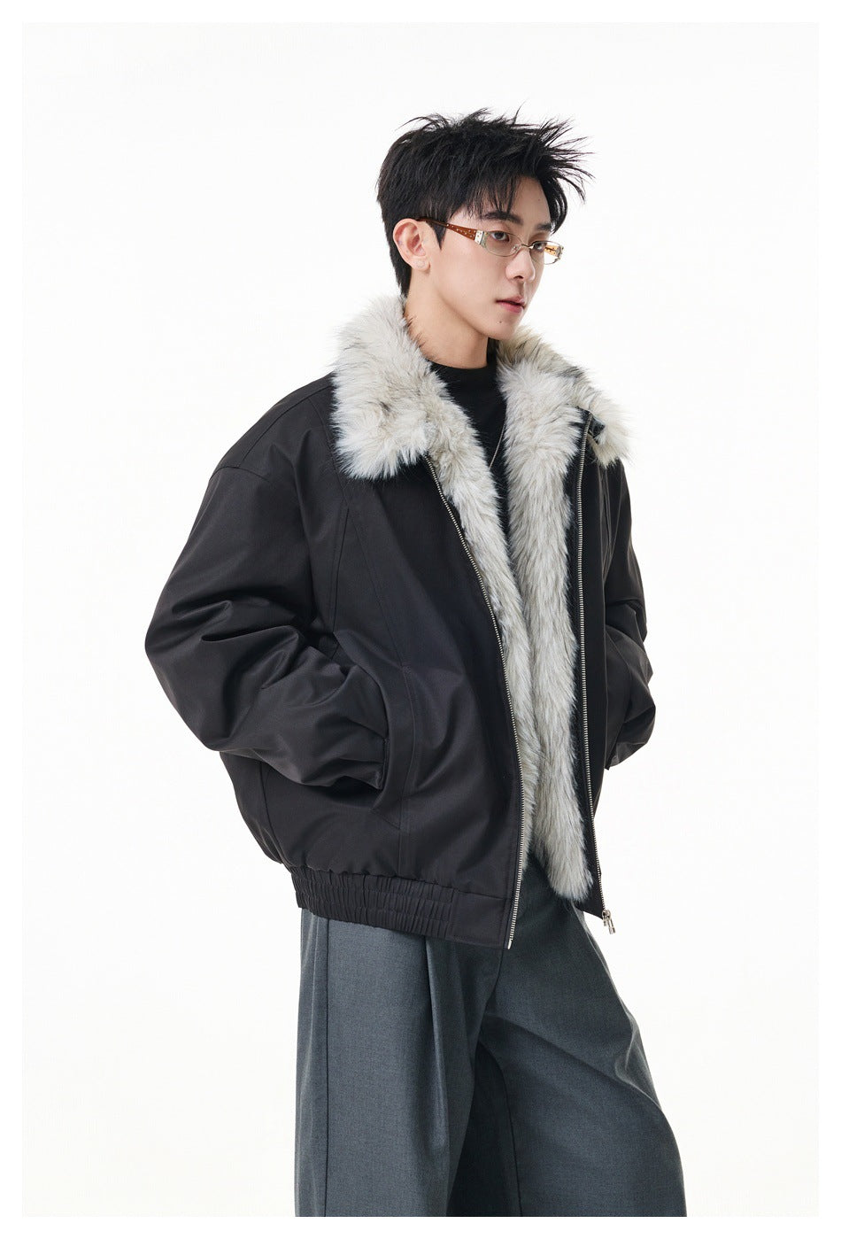 Model wearing a black jacket with a light gray faux-fur collar and lining, shown from the front at an angle.