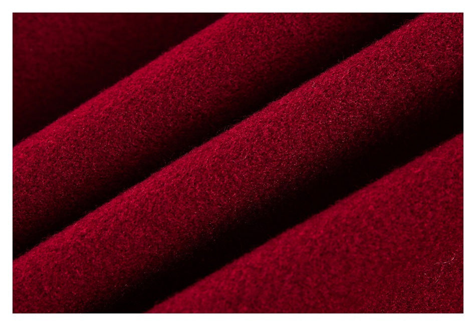 Extreme close-up of the textured burgundy garment fabric.