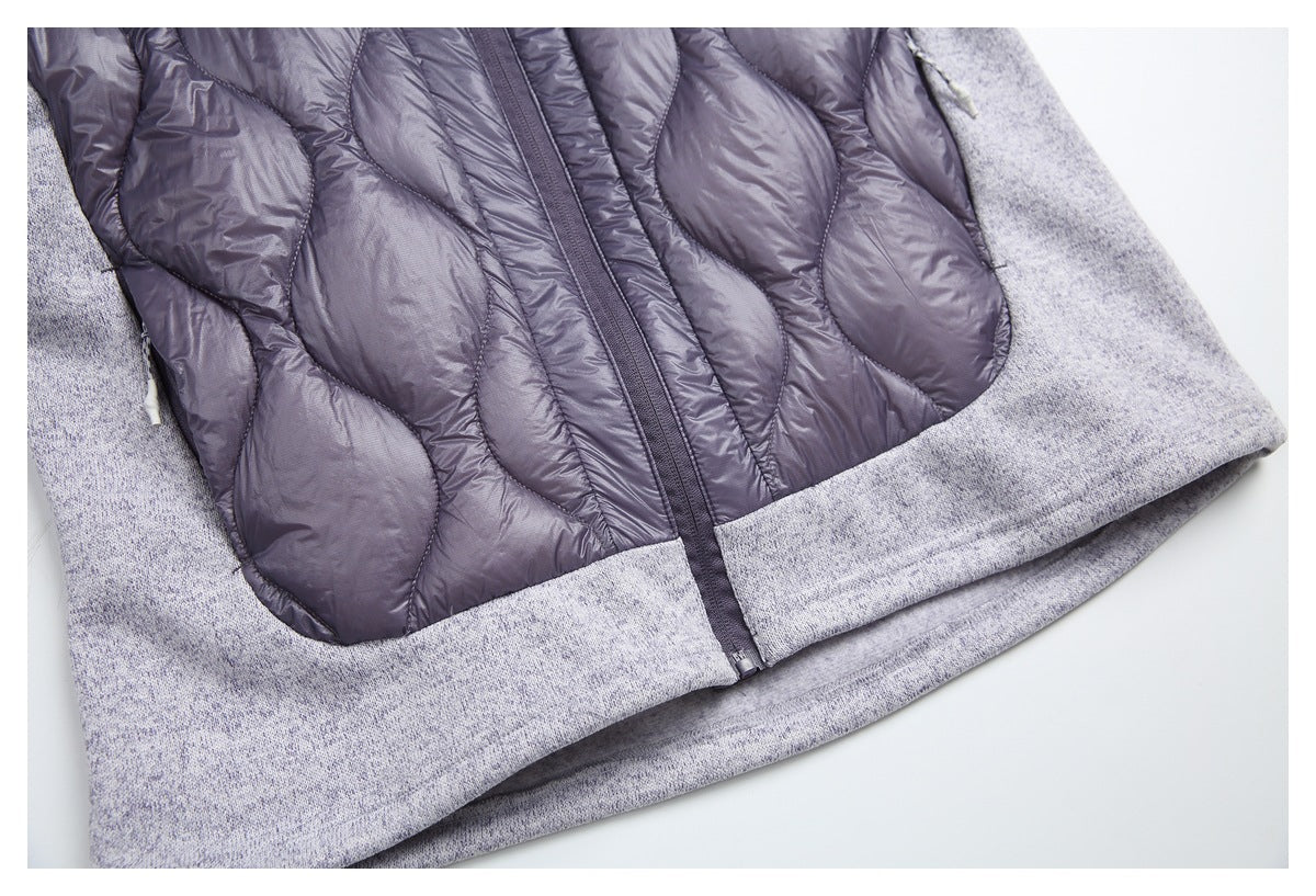 Close-up of the jacket’s plum quilted front, center zipper, and light gray marled knit hem and sleeves.
