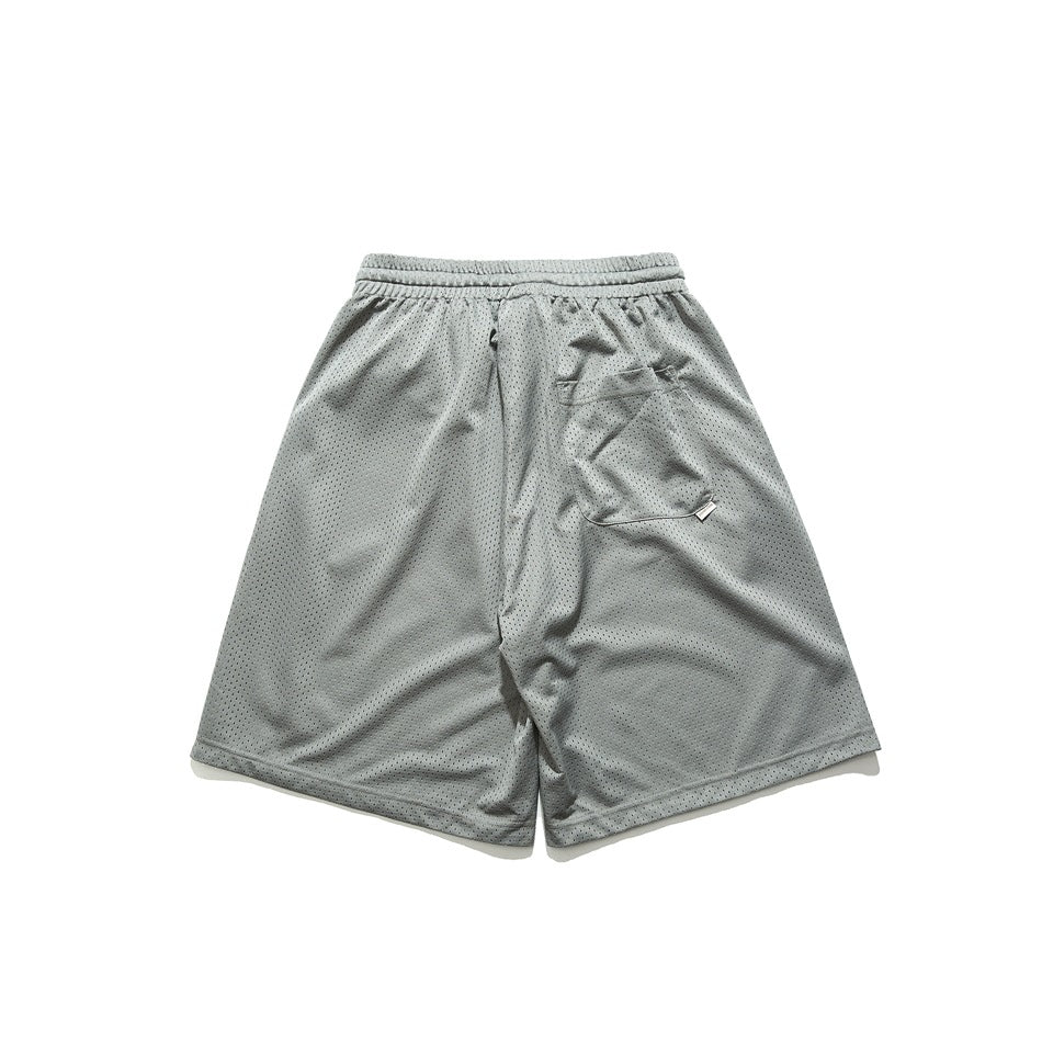 Back view of light gray perforated mesh shorts with an elastic waistband and a rear pocket.