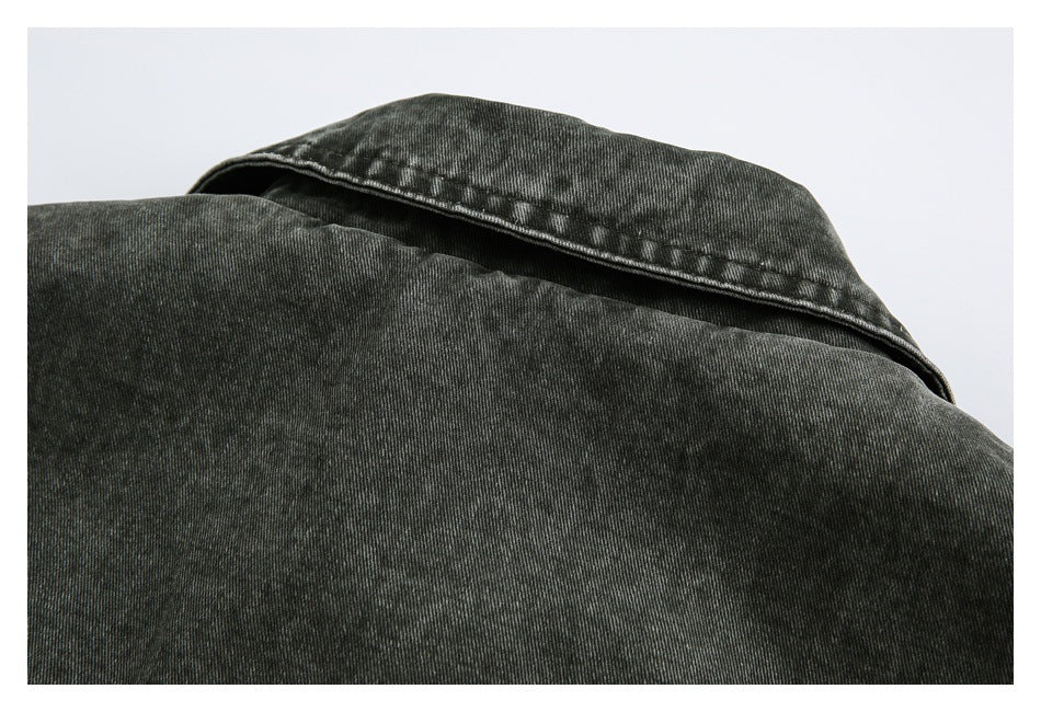 Close-up of a charcoal-black garment collar and upper back with visible stitching.
