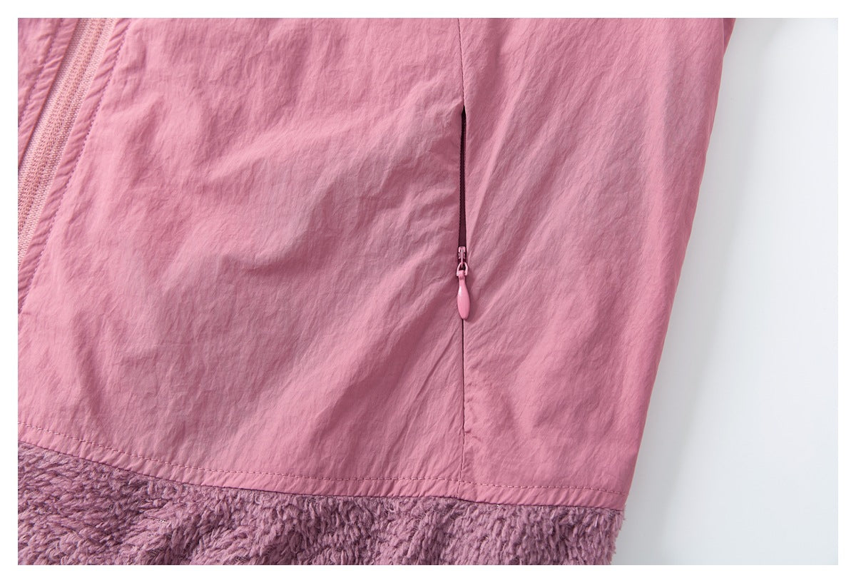 Close-up of a vertical zip pocket on the pink jacket, with plush mauve lining visible at the hem.